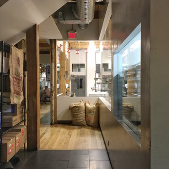 Soma Chocolatemaker - The chocolate making area leading to some tables in the back - Chocolatiers & Shops Near Me - Toronto, Ontario