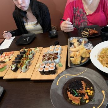 Ozaki Chinese Japanese - two women sitting at a table with plates of food - Asian Fusion Near Me - Clementon, New Jersey