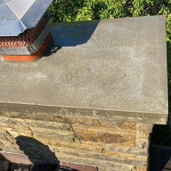 TAC-1 Services - a chimney cap on a brick chimney - Chimney Sweeps Near Me