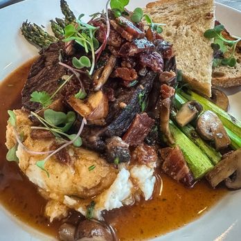 Delicioso Bistro - Short Ribs. Slow roasted short ribs, mashed potatoes, vegetables, cremini mushrooms, truffle demi-glace. - Diners Near Me - Modesto, California