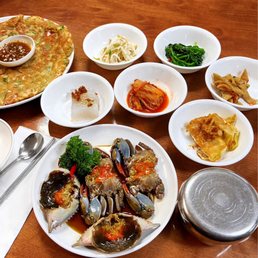 Seafood pancake, banchan, raw marinated crabs Seafood pancake, banchan, raw marinated crabs