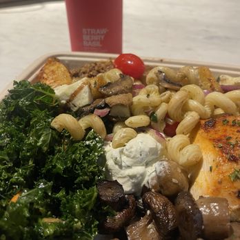 Living Green Cafe - Kale, chicken breast, mushrooms, feta macaroni salad, potato wedges topped with tzatziki sauce & paired with a strawberry basil soda - Juice Bars & Smoothies Near Me - Boca Raton, Florida