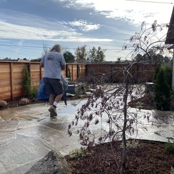 Jay Welty Landscaping - Large stone, free form, patio replaced lawn and cement.  Areas for planting were carved out, as well as a space for a custom fountain. - Landscaping Near Me
