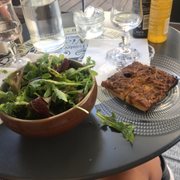 Photo of Chez Pipo - Nice, France. Mesculun and the pissaladière. The salad is plain with just greens. You need to dress it yourself