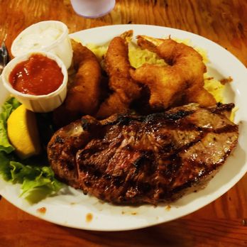Tack Room Restaurant & Bar - a plate of steak, onion rings, onion rings, onion rings, and a salad - Diners Near Me - Penn Valley, California