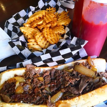 Cleavers - Cheesesteak with Swiss cheese and onion on a seeded bun and waffle fries - Cheesesteaks Near Me - Philadelphia, Pennsylvania Cleavers - Cheesesteak with Swiss cheese and onion on a seeded bun and waffle fries - Cheesesteaks Near Me - Philadelphia, Pennsylvania