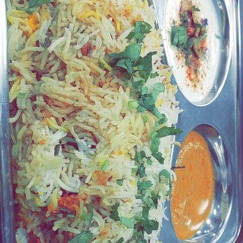 Desi Dhaaba - Chicken biryani, really great portion for only $8. The spicy is complimented with that creamy white sauce you see that helps tone it down. - Indian Near Me - Gurnee, Illinois