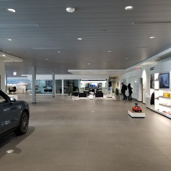 Porsche Chantilly - Second floor looking towards restrooms. People in the photo are near the service window. To the right would be the long hallway. - Car Dealers Near Me - Chantilly, Virginia
