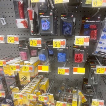 Walmart - Electrical connectors and tools are arranged on a pegboard display in a hardware store, with price tags visible. - Department Stores Near Me - Burke, Virginia