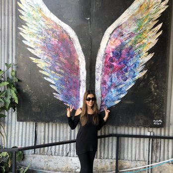 Artisan Premium Jerky - a woman standing in front of a painted angel wings - Specialty Food Near Me - Los Angeles, California Artisan Premium Jerky - a woman standing in front of a painted angel wings - Specialty Food Near Me - Los Angeles, California