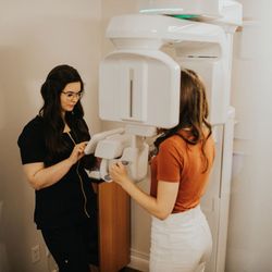 Kelowna Dental Centre - Dental assistant taking CBCT scan of patient at Kelowna Dental Centre
