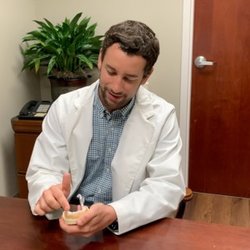 Blake Nelson DDS Cosmetic, Implant & Sedation Dentistry - Dr. Blake Nelson explaining a dental procedure to a patient