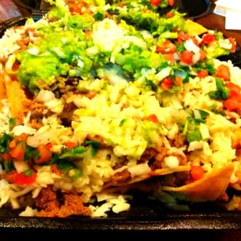 Tom's Tailgate - Carne Asada Nachos w/the works! Carne, Black Beans, Rice, Cheese, Pico, Cilantro,  Guacamole, both red & green salsa on the side - Mexican Near Me - La Mirada, California
