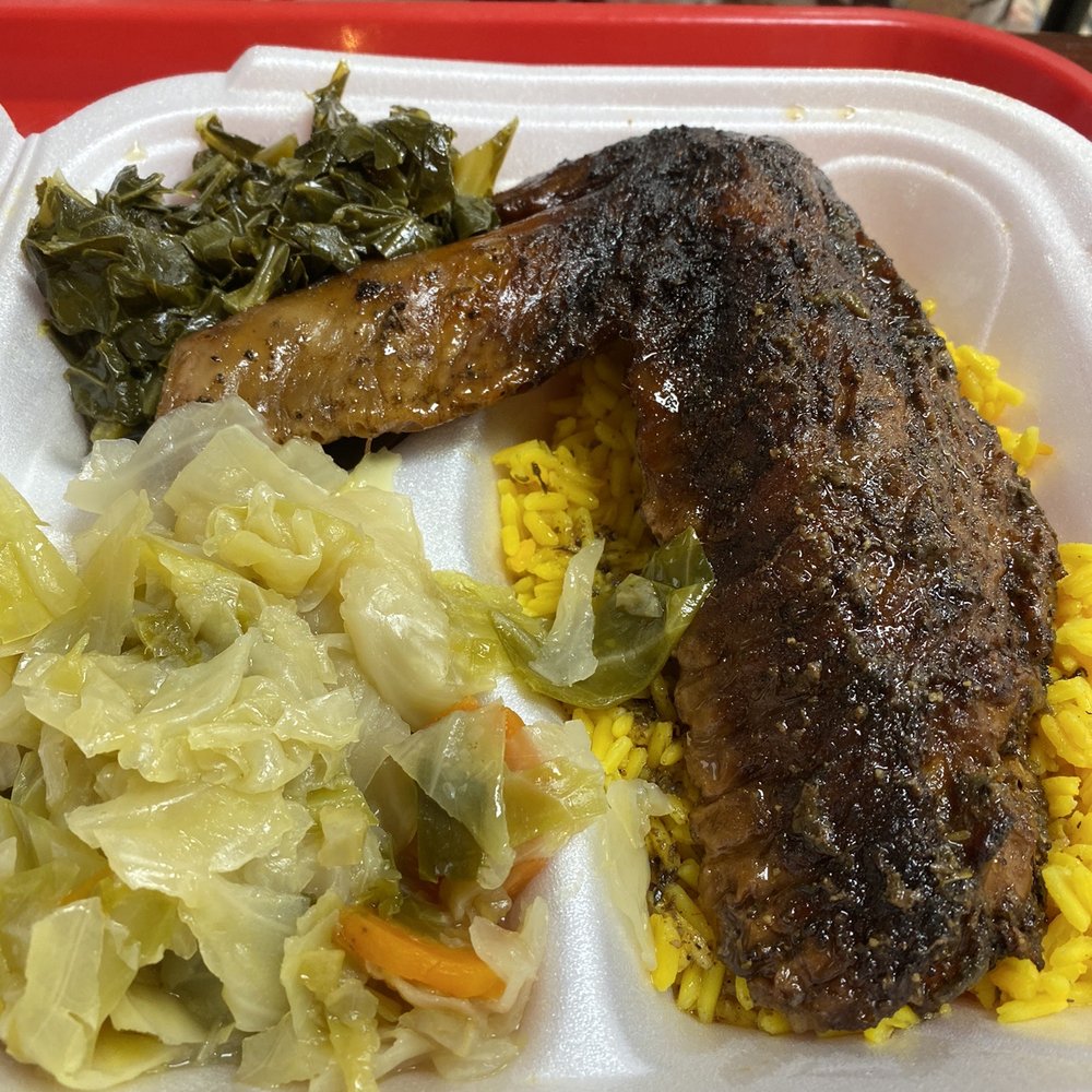 Big Daddy's Kitchen - Jerk turkey wing on a bed of rice, cabbage and greens - Soul Food Near Me - Atlanta, Georgia