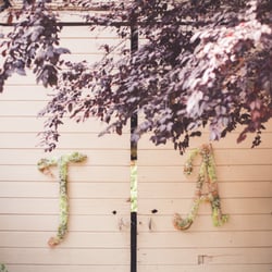 KM Floral Design - A perfect start to the reception! Bride & Groom initials on the barn doors into the reception.