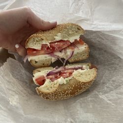 Sesame toasted bagel with scallion cream cheese, tomato, onion