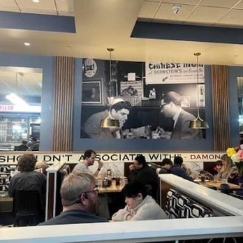 Maven's Delicatessen - my friend and I sitting in the booth ironically mimicking the mural above. - Bakeries Near Me - Pawtucket, Rhode Island Maven's Delicatessen - my friend and I sitting in the booth ironically mimicking the mural above. - Bakeries Near Me - Pawtucket, Rhode Island