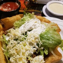 a taco salad with lettuce and cheese