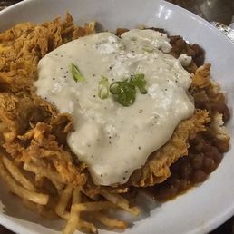 Chicken Fried Steak served over French fries and red beans and rice.