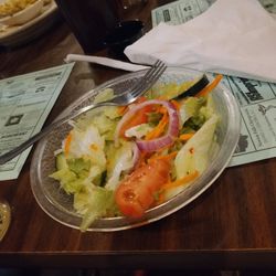 Covered Bridge Inn - A salad with tomatos cucumbers sliced carrots letus and unions. With Italian dressing.