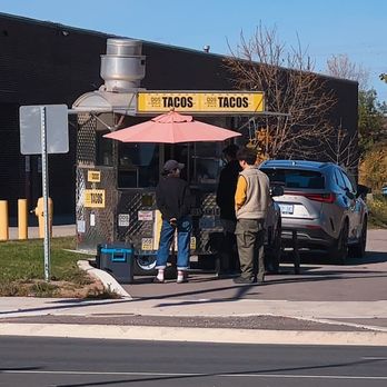 Dos Amigos Tacos - a man standing in front of a taco stand - Food Trucks Near Me - Markham, Ontario