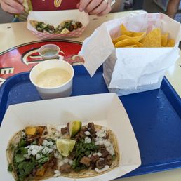 Al pastor taco, bistec taco, chips and queso