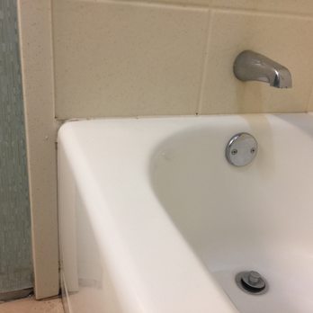 Hampton Inn Rehoboth Beach - This is how your bathroom might look like, around the bath tub and missing tile, - Hotels Near Me - Rehoboth Beach, Delaware Hampton Inn Rehoboth Beach - This is how your bathroom might look like, around the bath tub and missing tile, - Hotels Near Me - Rehoboth Beach, Delaware