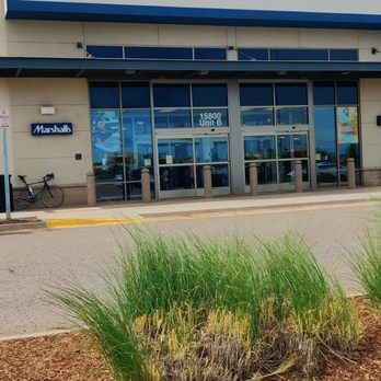 Marshalls - Front of building - Exterior view of a Marshalls store with glass entrance doors, a large sign, and a small Marshalls sign on the side wall. - Department Stores Near Me - Aurora, Colorado