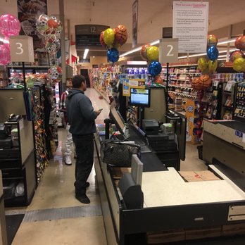 Safeway - a man standing at a cash register in a grocery store - Grocery Near Me - Santa Rosa, California