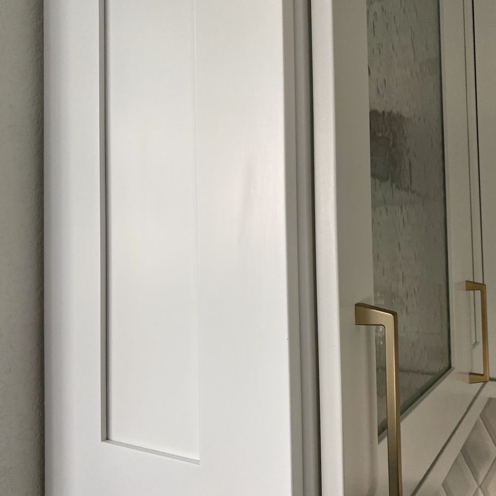 a white cabinet with a glass door