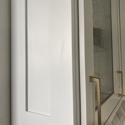 a white cabinet with a glass door