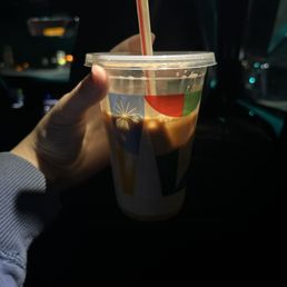 a hand holding a cup of coffee