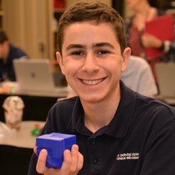 St Dominic Savio Catholic High School - Student proudly holds up his cube he designed and printed with a 3D printer.