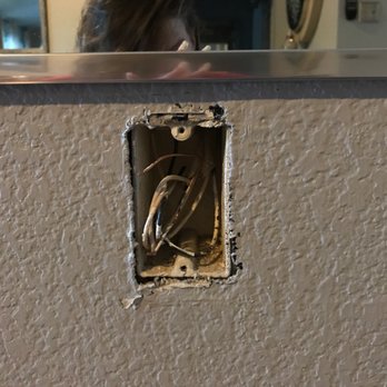 Getz Handyman - This is the outlet the employee said he could not get shoved into the wall so he cut it on his own! - Handyman Near Me