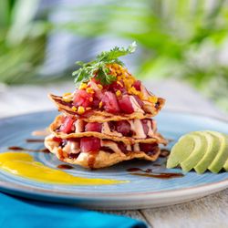 Bahama Breeze - NEW! Tuna Tostada Stack - Ahi tuna poke layered with crispy tortillas, drizzled with a zesty lime aioli, served with avocado.