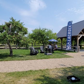 Cidrerie Lacroix - a picnic area with picnic tables and umbrellas - Cideries Near Me - Saint-Joseph-du-Lac, Quebec