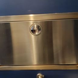 Changing table in the gender-neutral restroom... and it's feeling happy to see you!