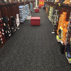 Shoe Dept. Encore - Multiple ottomans in nearly every aisle for trying on shoes.