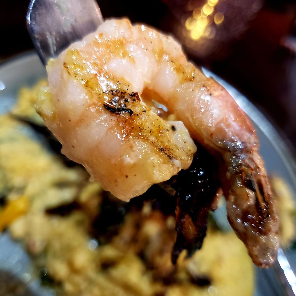 Kounter - Close up of shrimp from Shrimp & Grits (tail on?) - New American Near Me - Rock Hill, South Carolina