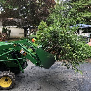 Extreme Outdoor Pros - a tractor with a loader full of tree branches - Landscaping Near Me - Pennington, New Jersey Extreme Outdoor Pros - a tractor with a loader full of tree branches - Landscaping Near Me - Pennington, New Jersey