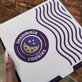 Insomnia Cookies - a hand holding a box of cookies - Food Delivery Services Near Me - Athens, Georgia Insomnia Cookies - a hand holding a box of cookies - Food Delivery Services Near Me - Athens, Georgia