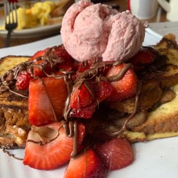 a plate of french toast with ice cream and strawberries a plate of french toast with ice cream and strawberries