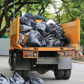 Lovelyxpress - a garbage truck loaded with garbage bags - Junk Removal & Hauling Near Me Lovelyxpress - a garbage truck loaded with garbage bags - Junk Removal & Hauling Near Me