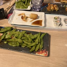 Green bean egg rolls Sushi and empty glasses