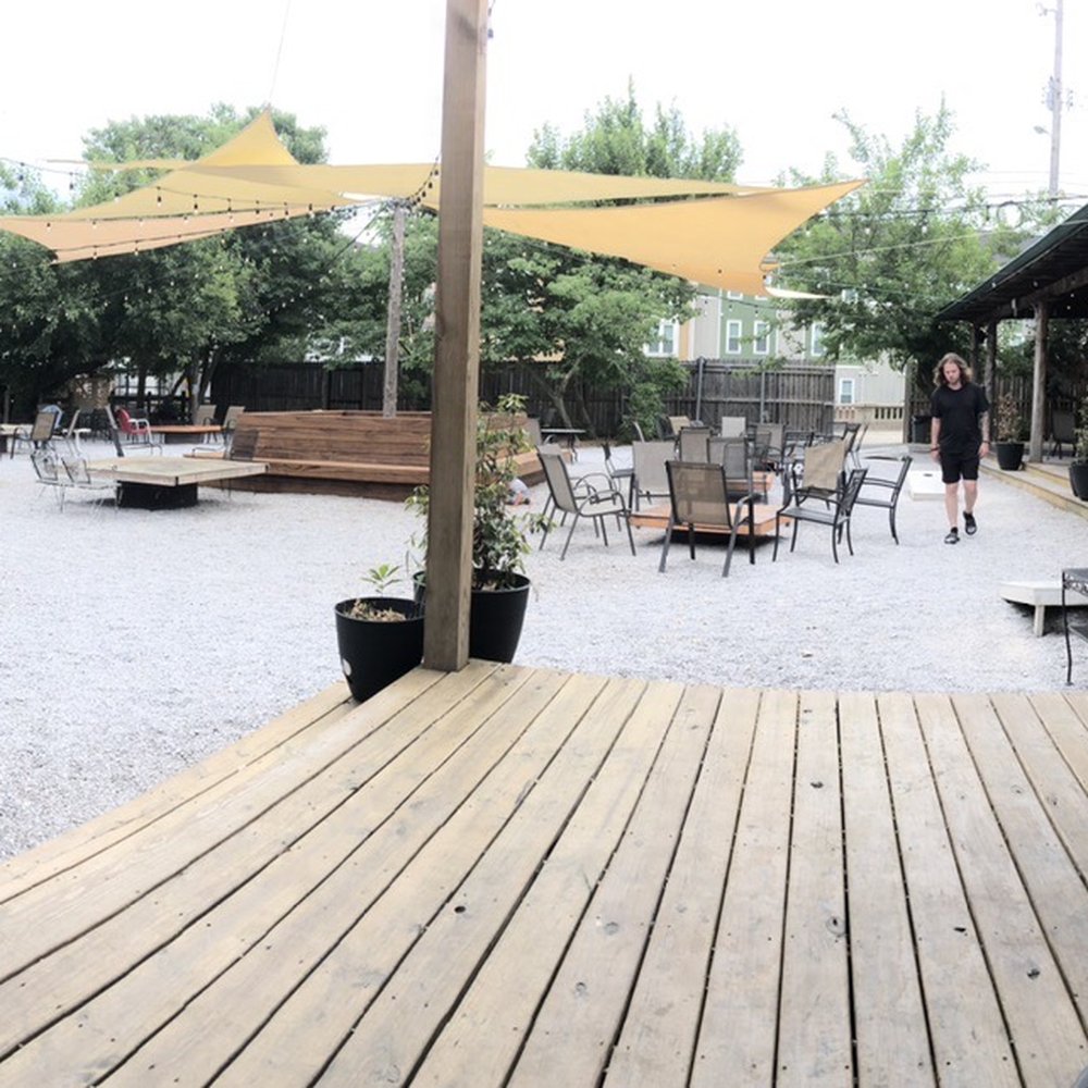 Loflin Yard - a patio with tables and chairs - New American Near Me - Memphis, Tennessee Loflin Yard - a patio with tables and chairs - New American Near Me - Memphis, Tennessee
