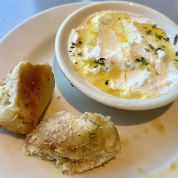 Bazille - Already bitten into Parmesan Garlic Ciabatta with ricotta honey spread - New American Near Me - San Antonio, Texas