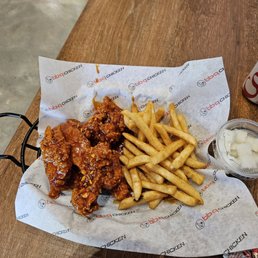 Boneless wings with special sauce, french fries and pickled radish.