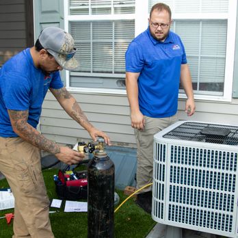 Just In Case Mechanical - two men working on an air conditioner - General Contractors Near Me - Lititz, Pennsylvania Just In Case Mechanical - two men working on an air conditioner - General Contractors Near Me - Lititz, Pennsylvania