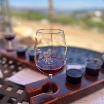 Hungry Hawk Vineyards & Winery - a glass of wine on a table - Wineries Near Me - Escondido, California Hungry Hawk Vineyards & Winery - a glass of wine on a table - Wineries Near Me - Escondido, California