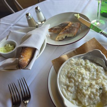 La Petite Grocery - Stone Ground Grits with baguette with herb butter - French Near Me - New Orleans, Louisiana